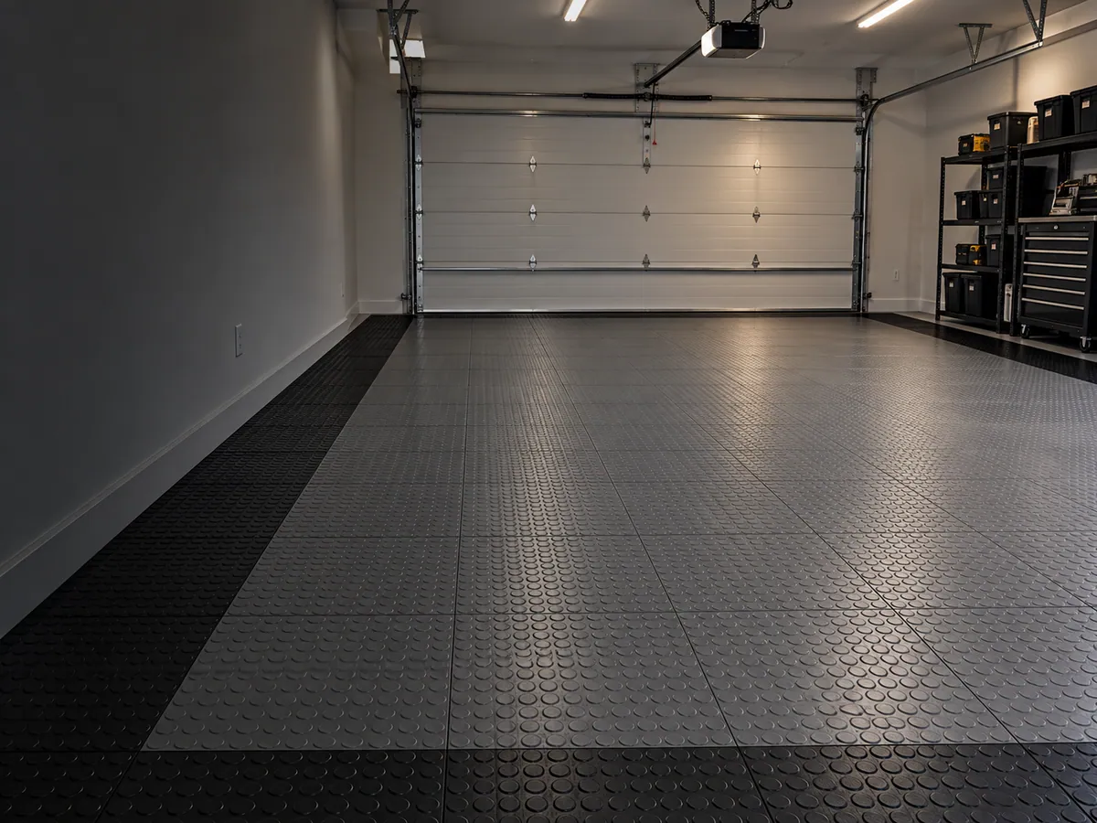 Residential garage floor in interlocking modular tiles with a black perimeter border