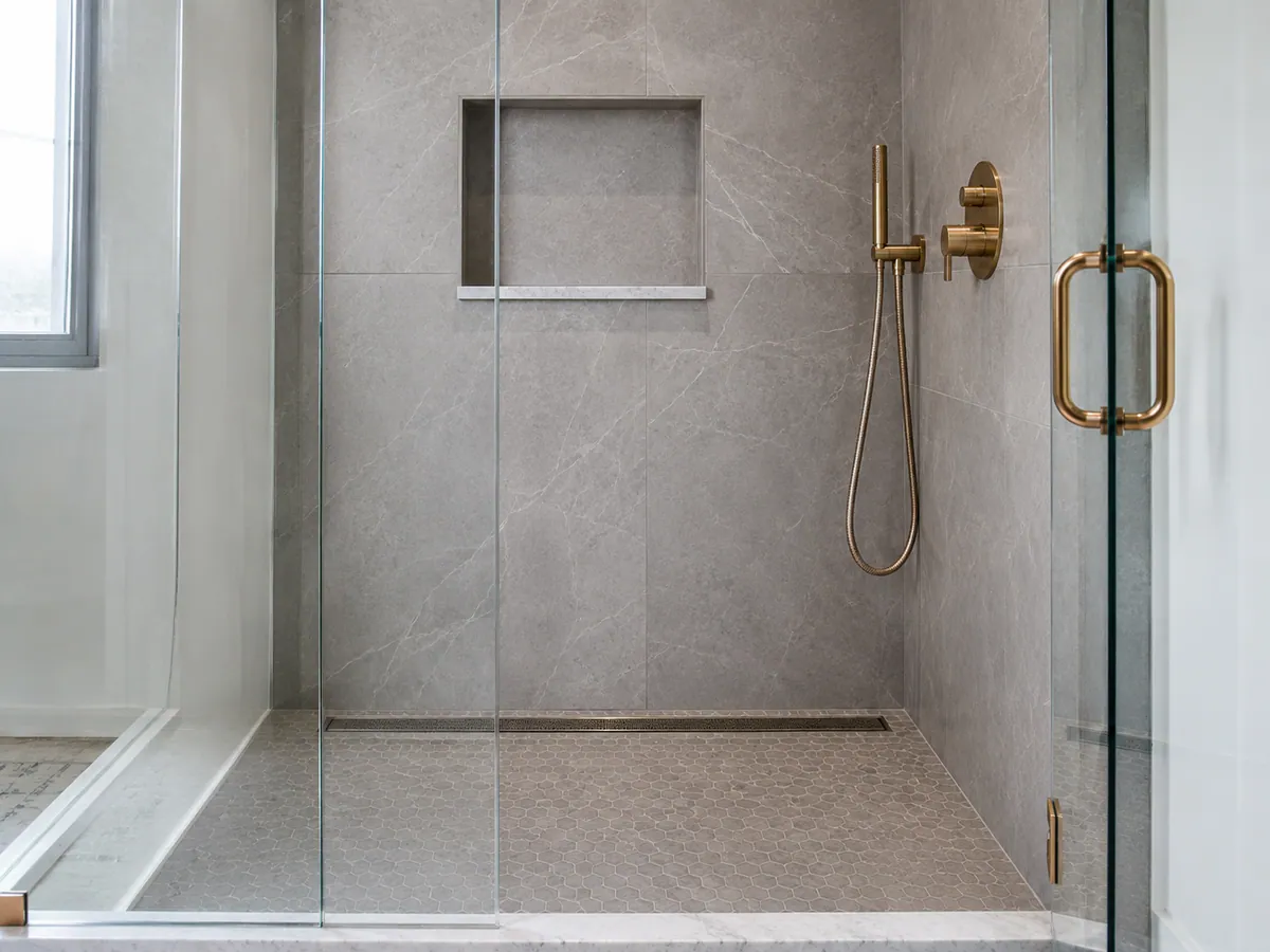 Tiled walk-in shower with niche and linear drain